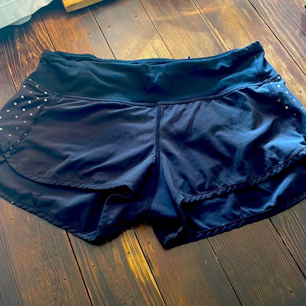 Lululemon Run Speed Shorts, black with dots, Size 4. 2 small paint dots shown